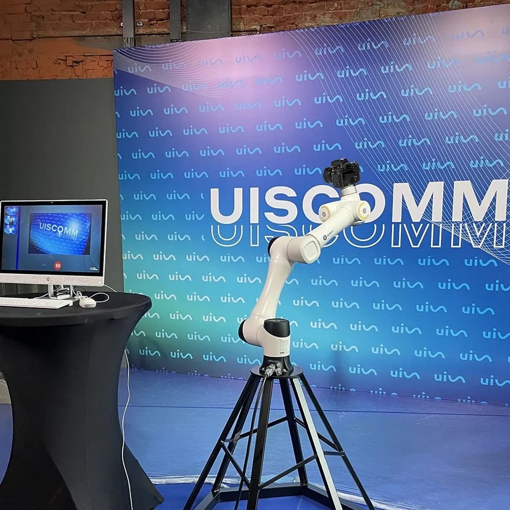 Глэмбот на фоне брендированного стенда