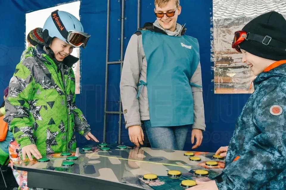 Дети соревнуются на реакцию, ассистент рядом помогает