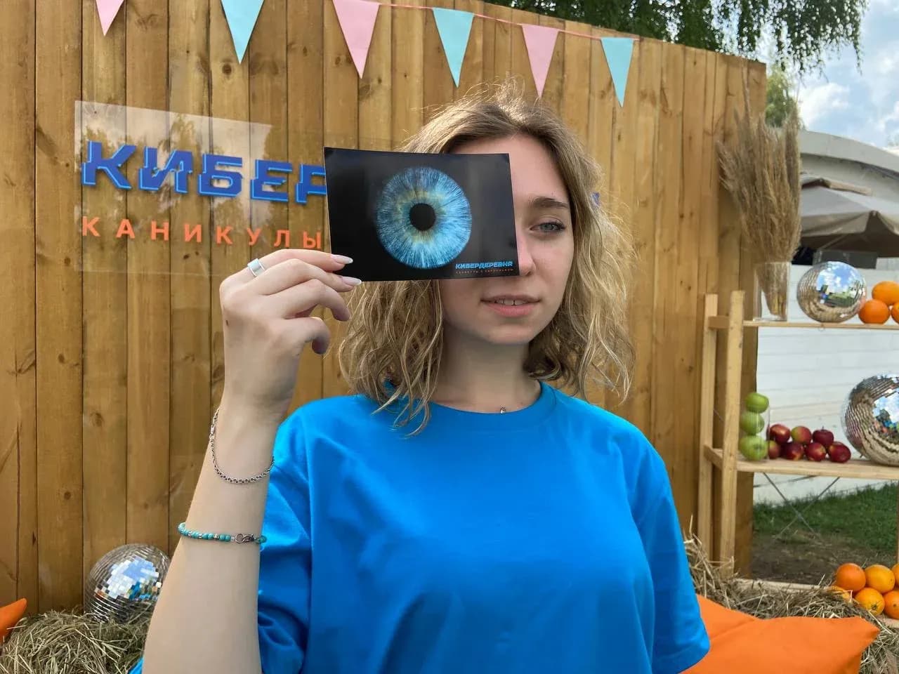 Гость на мероприятии держит в руках снимок радужки